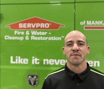 SERVPRO employee in front of green truck